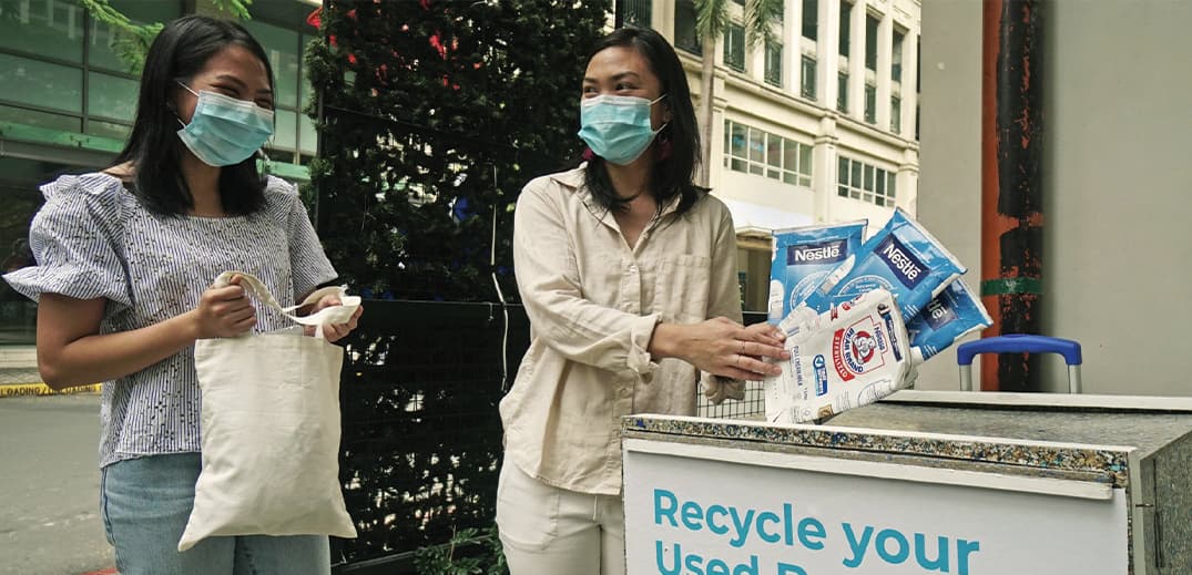 two women doing recycling